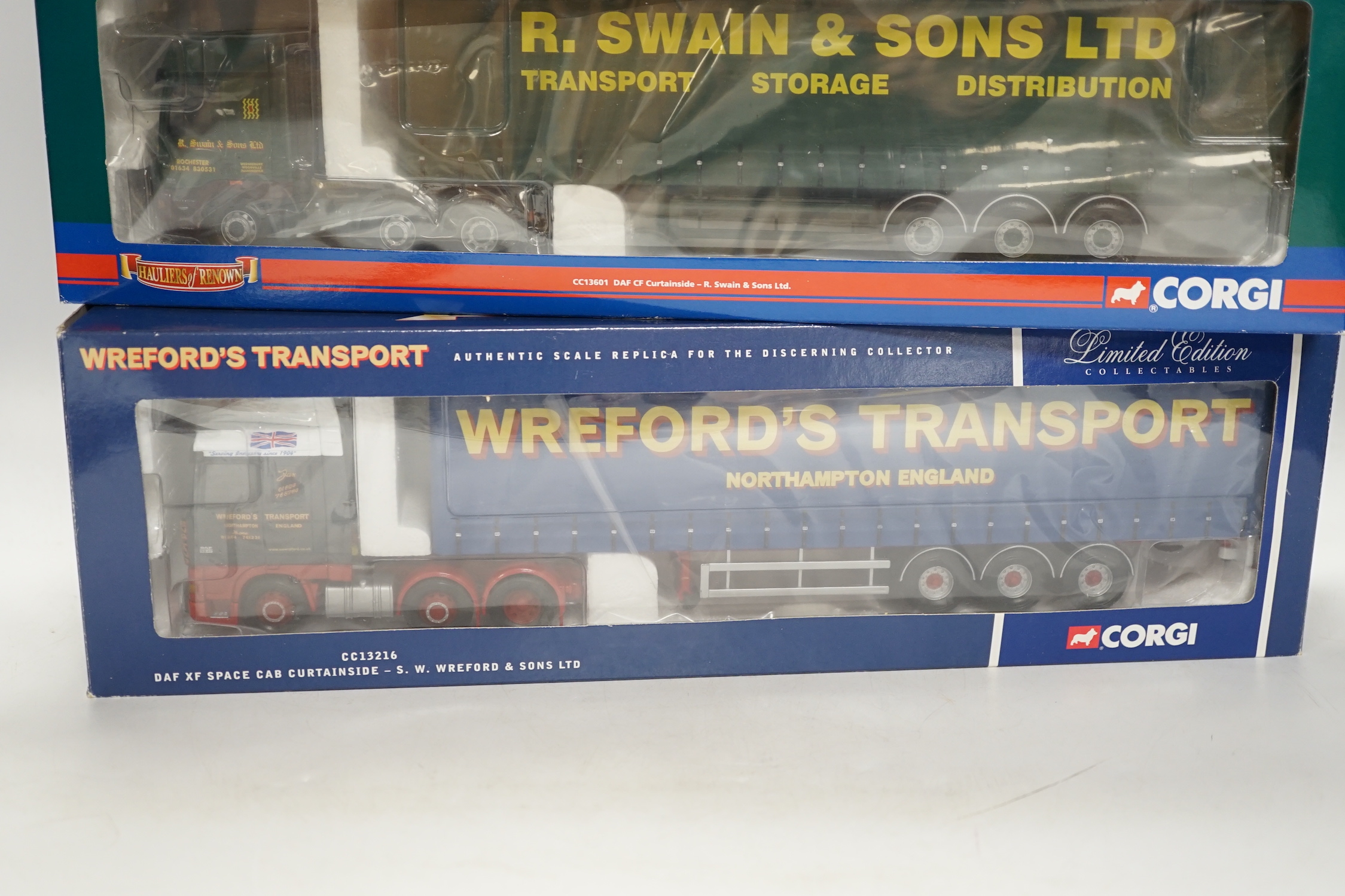 Four boxed Corgi 1:50 scale articulated trucks; a DAF CF curtainside (CC13601), a Volvo FM with box trailer (CC13506), a DAF XF Space Cab curtainside (CC13216), and a MAN TGX curtainside (CC15201)